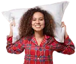 Woman in tartan pyjamas with pillow