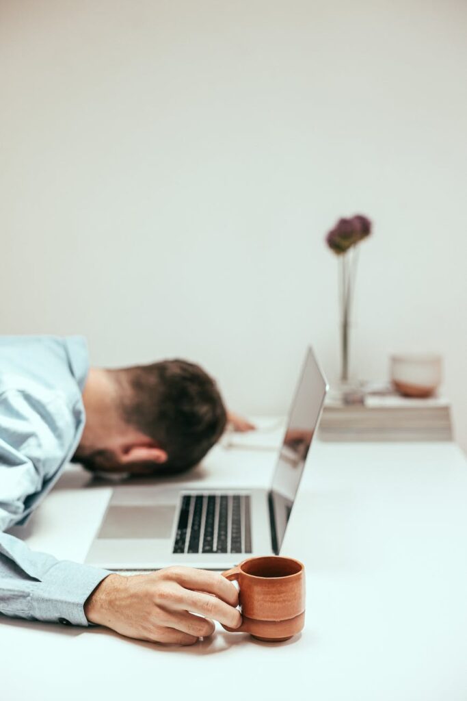 Man tired at work because he isn't getting enough sleep