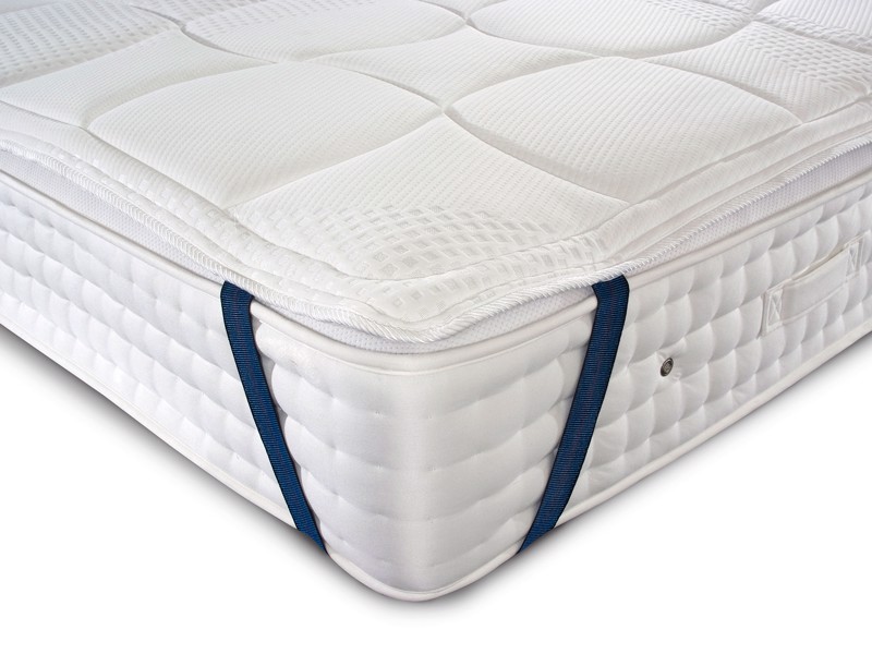 mattress topper tied to corner of a mattress