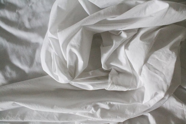 Crumpled White Bedding Sheets ready to go in the wash