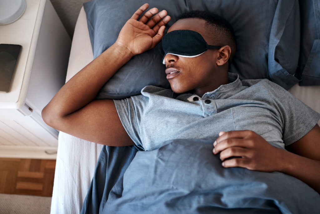 A man in bed experiencing the REM sleep stage