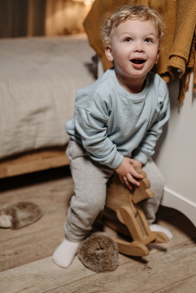 Child on tiny wooden horse