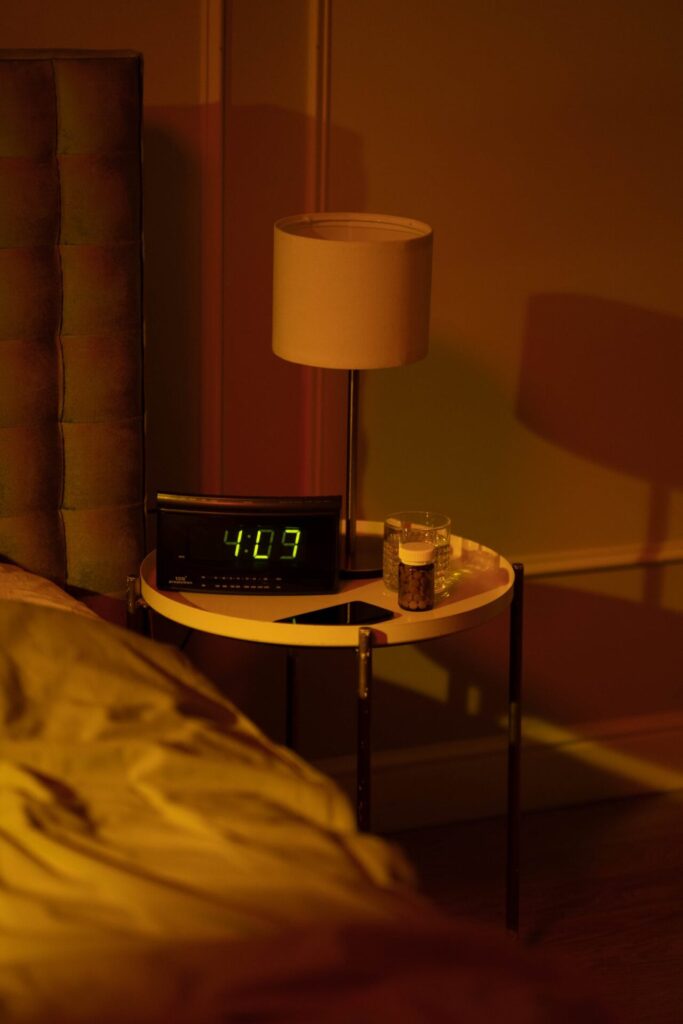 Digital alarm clock on bedside table in the early hours