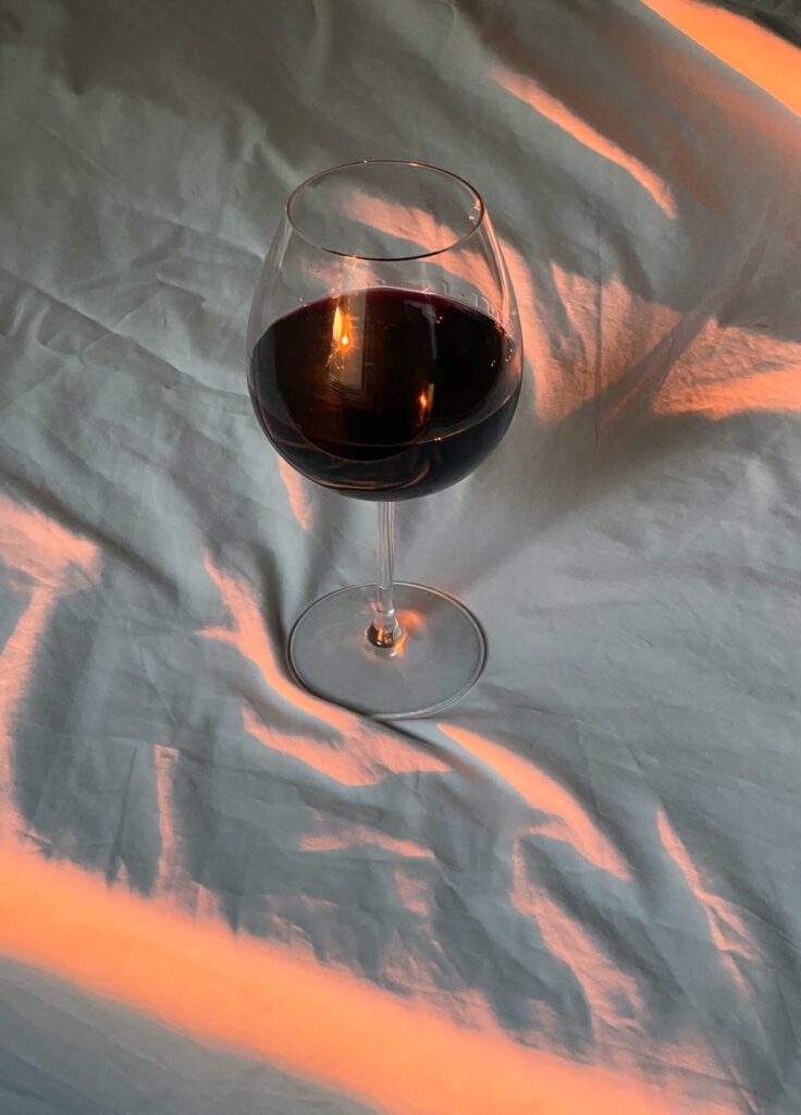 A glass of wine on a bed