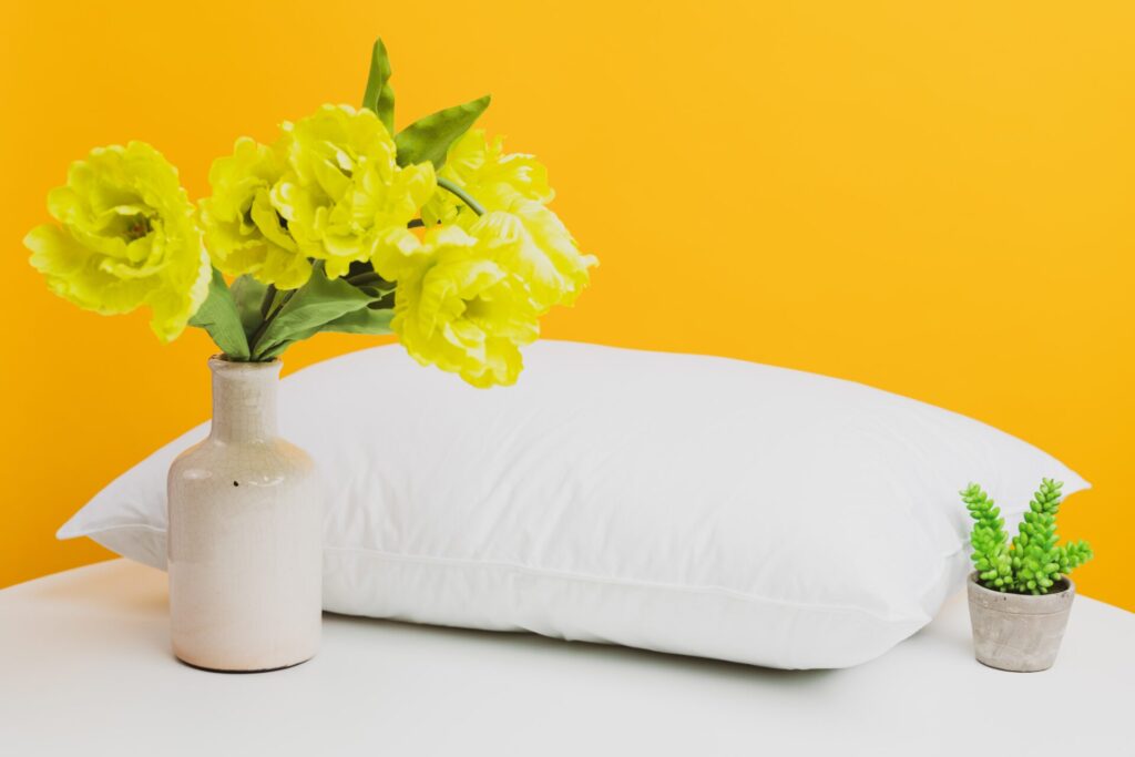 A Fresh White Pillow Accompanied By Plants 