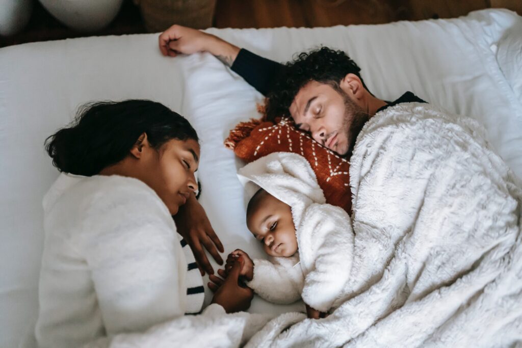 Family asleep lying on their sides. 