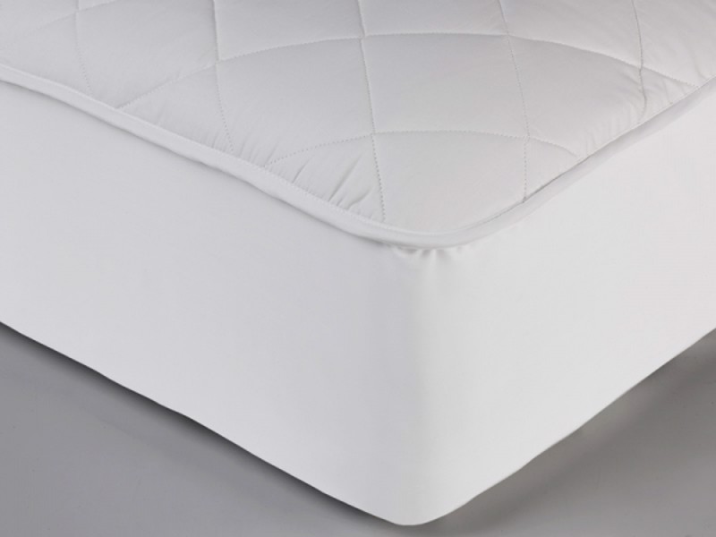 Wool mattress protector on a bed