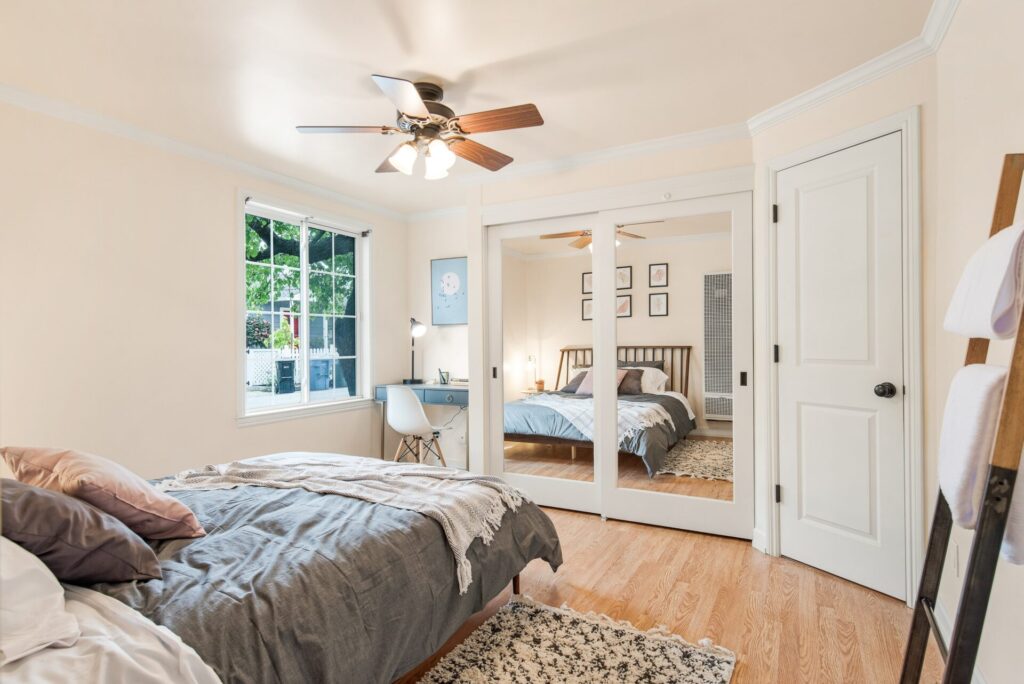 Stylish bedroom with a ceiling fan which keeps it cool