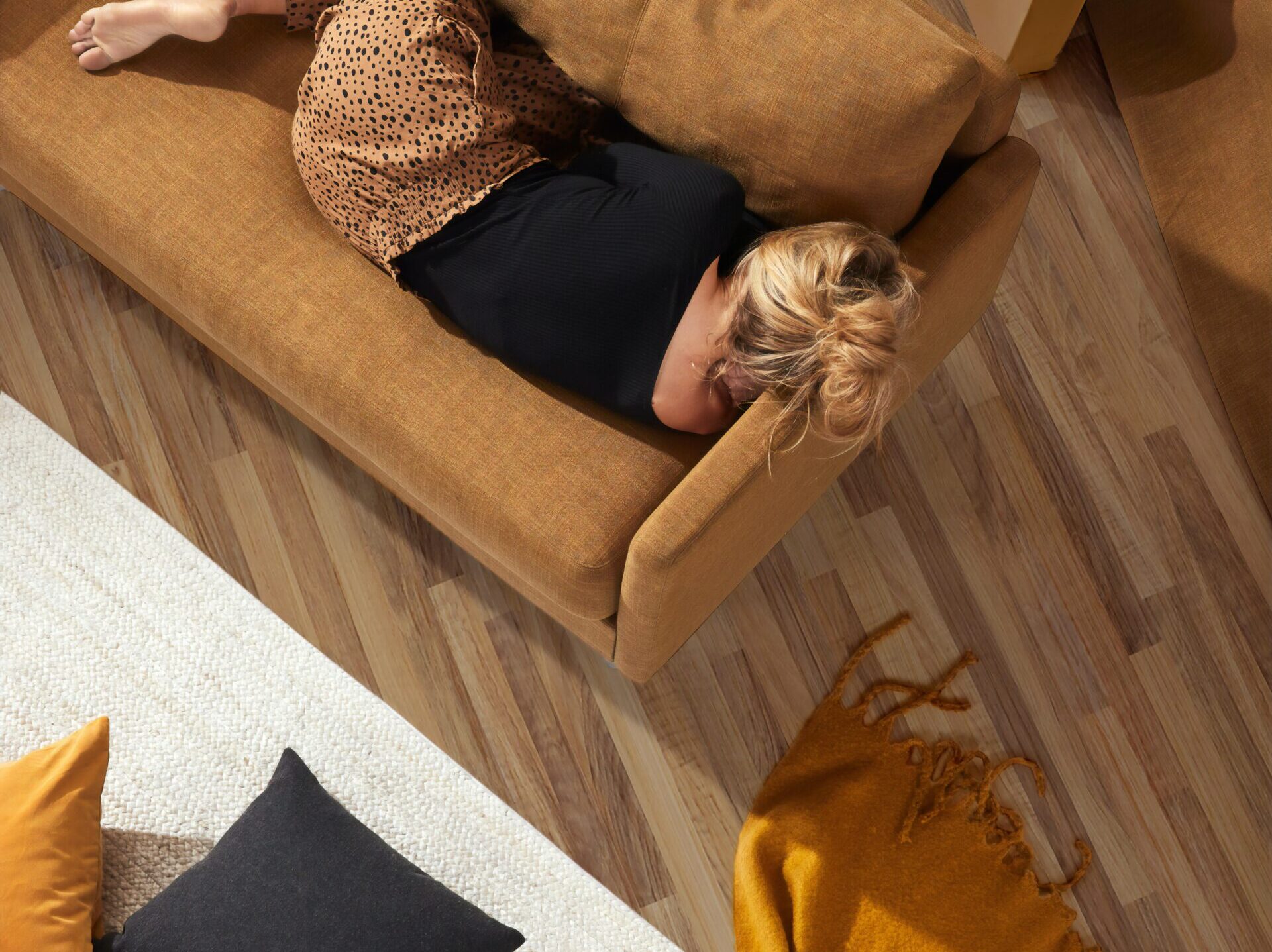 A blonde woman sleeping on a sofa