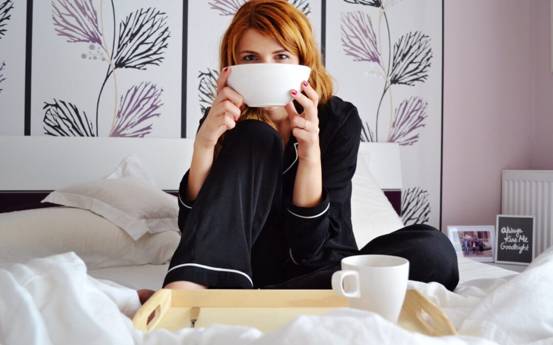 Woman in bed enjoying a cuppa