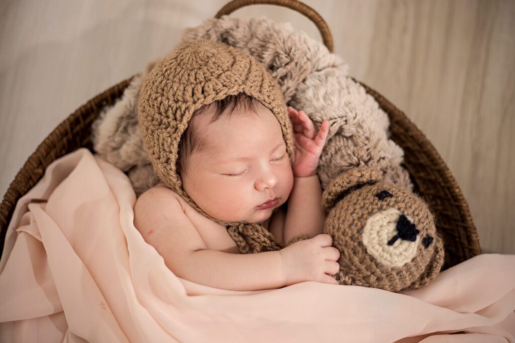 Baby boy dressed as a teddy bear sleeping