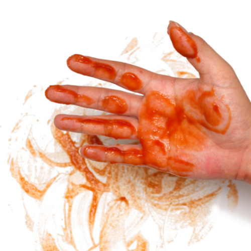 A hand covered in orange goo