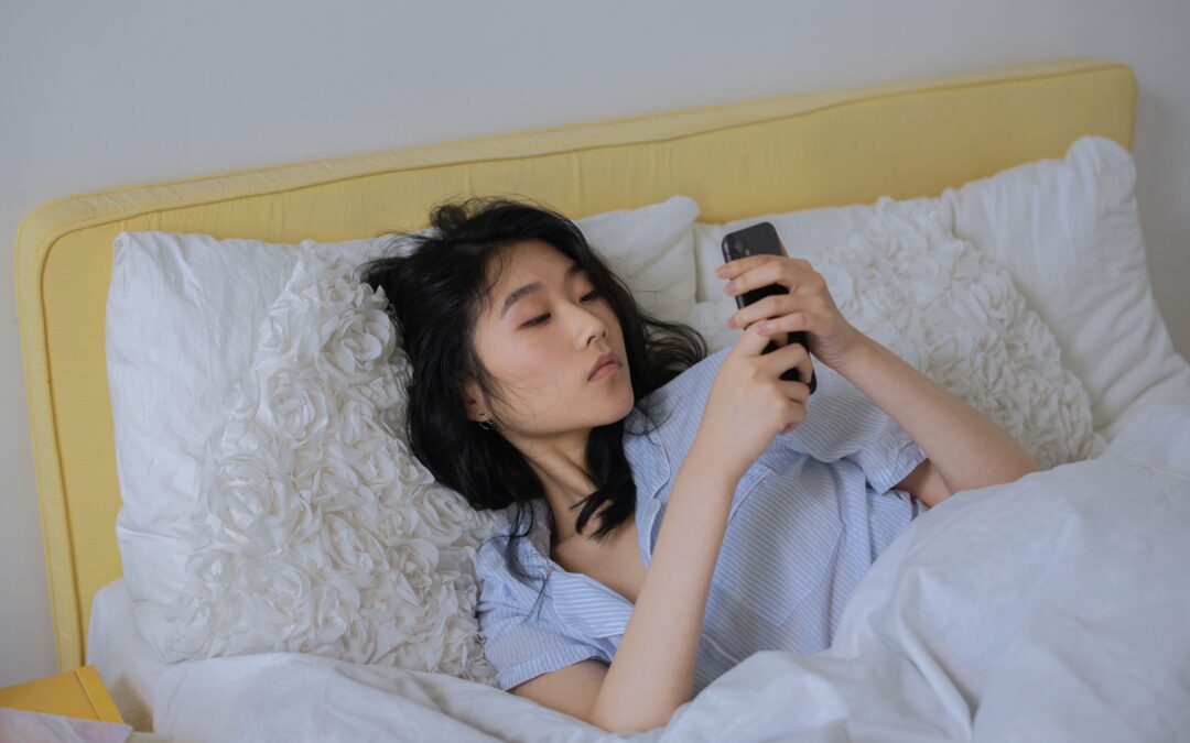 Woman scrolling #sleeptok in bed